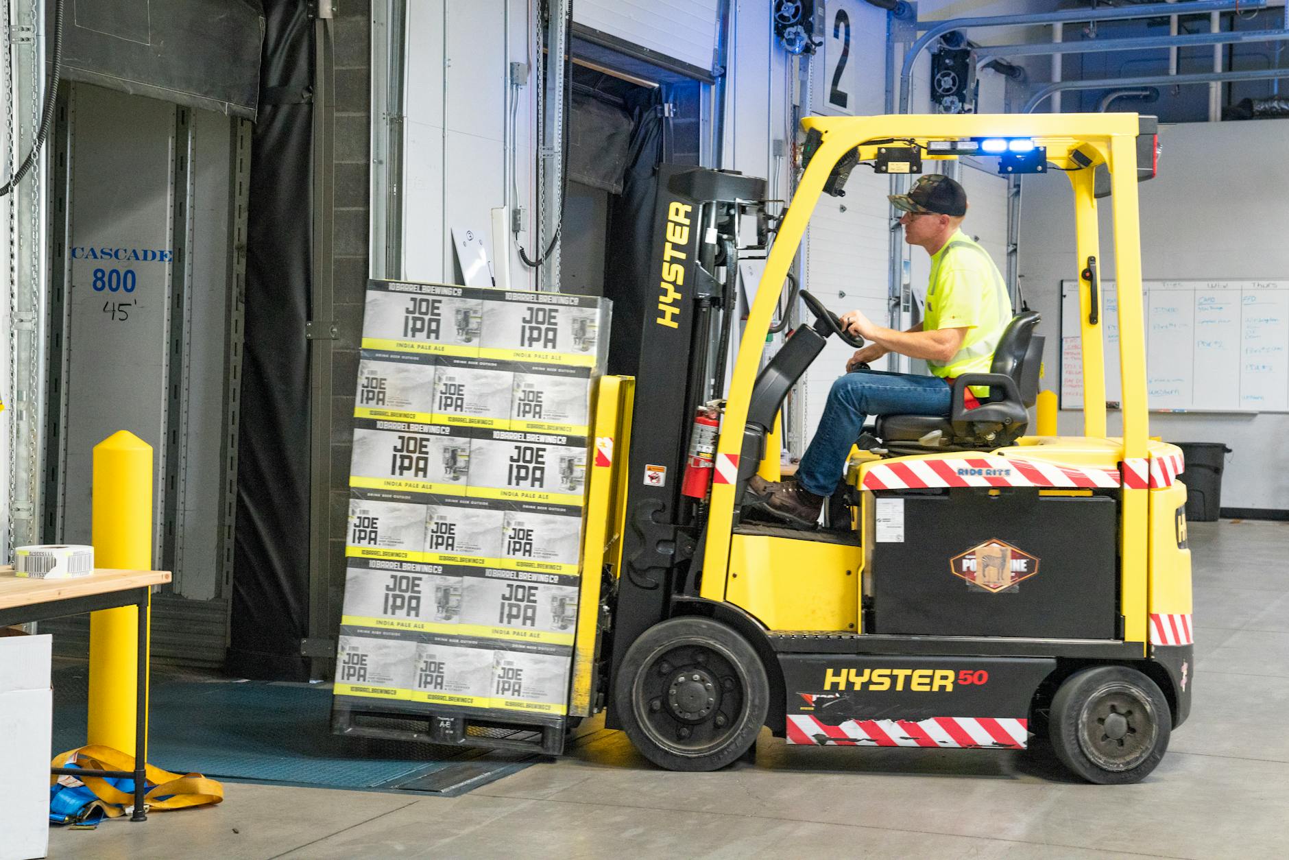 A pallet loaded with boxes on a forklift.